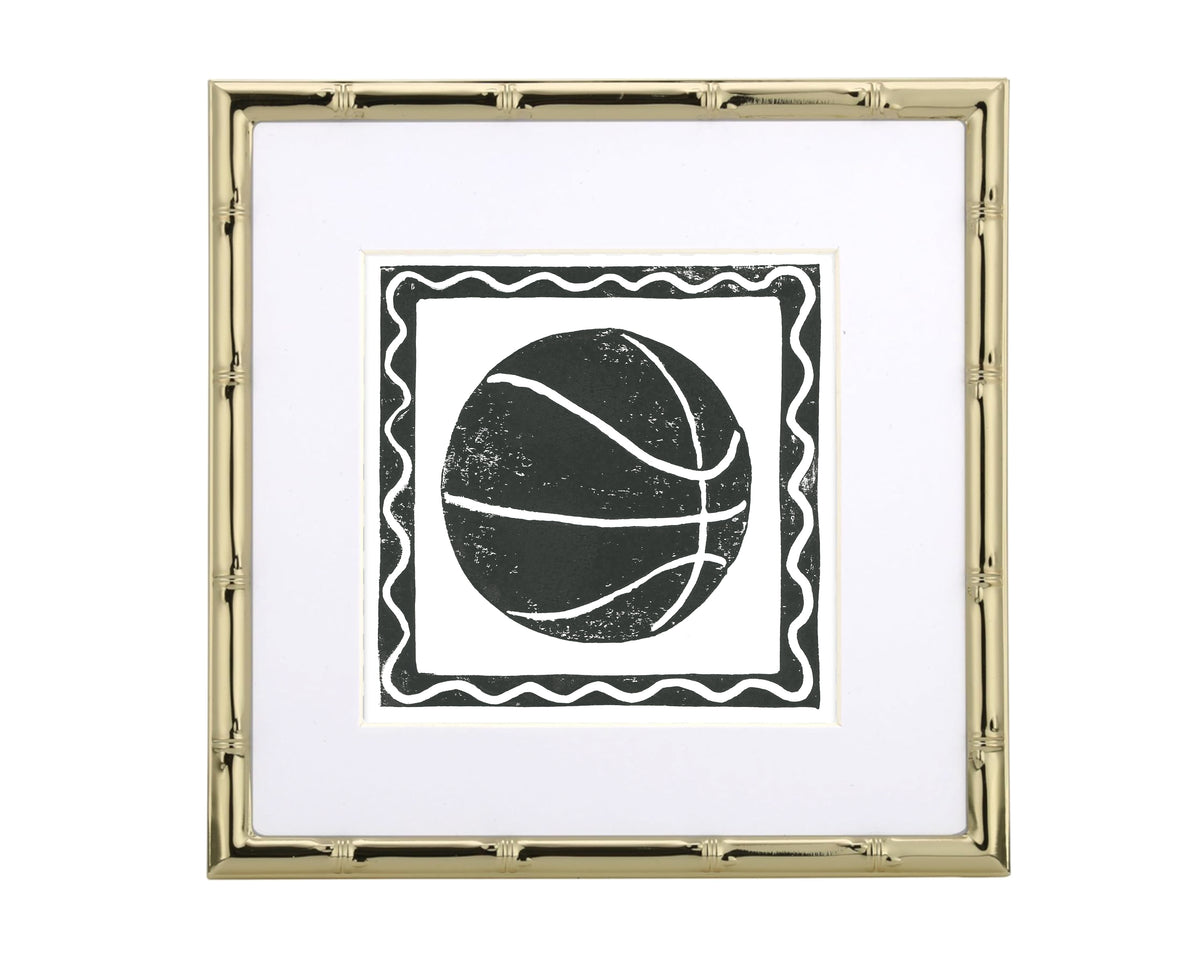 Framed artwork with a black and white ball design on a white background