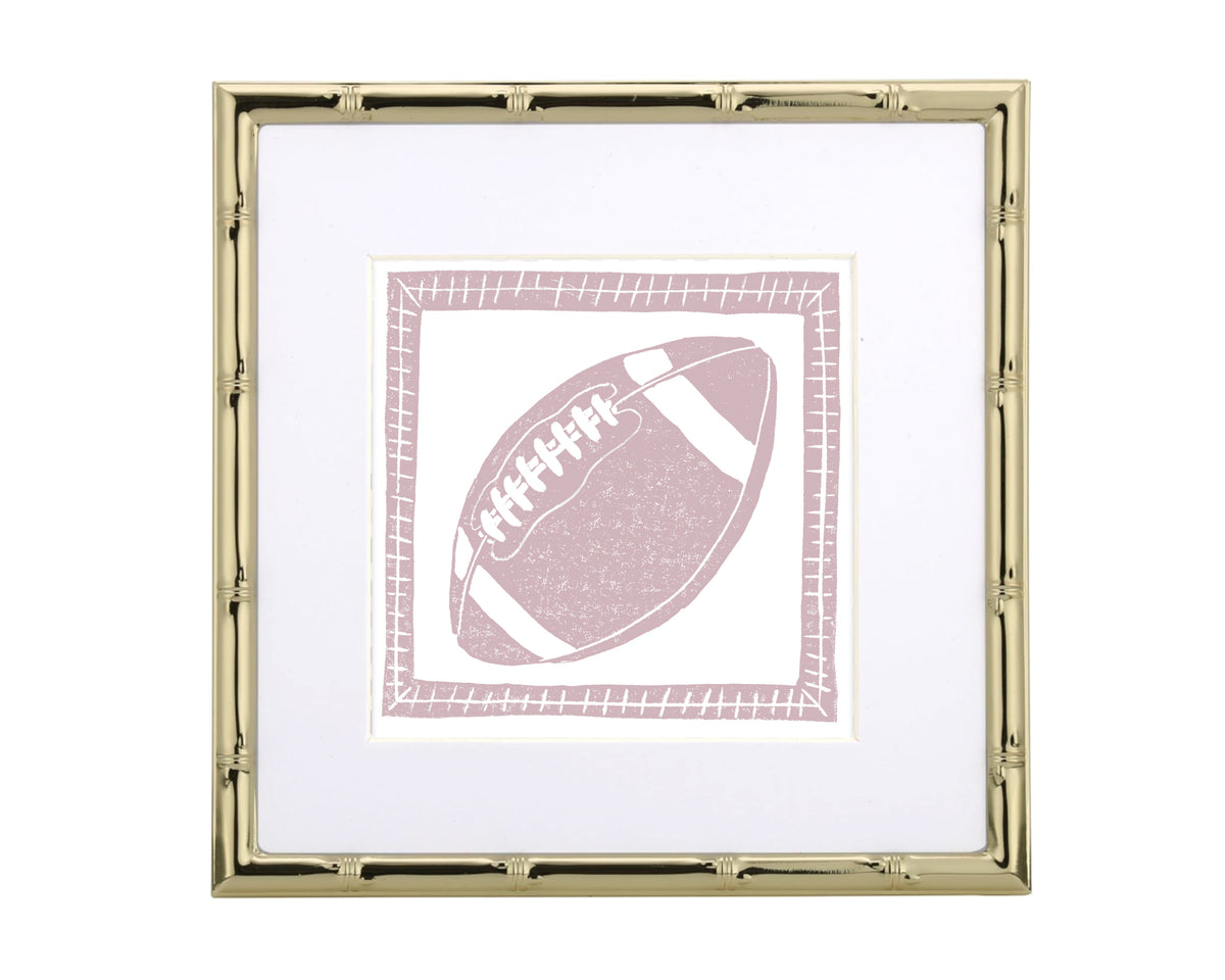 Framed artwork of a pink football on a white background