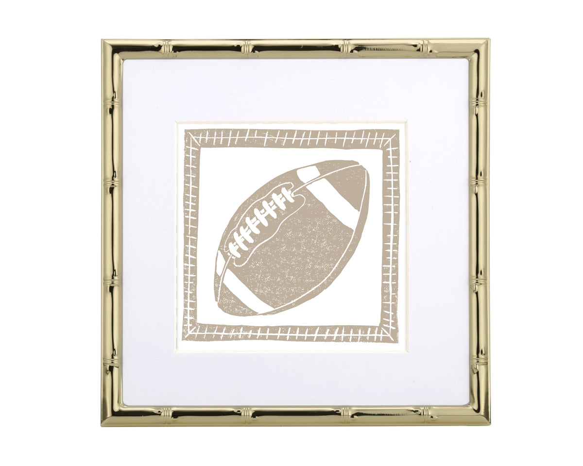 Framed artwork of a tan football on a white background