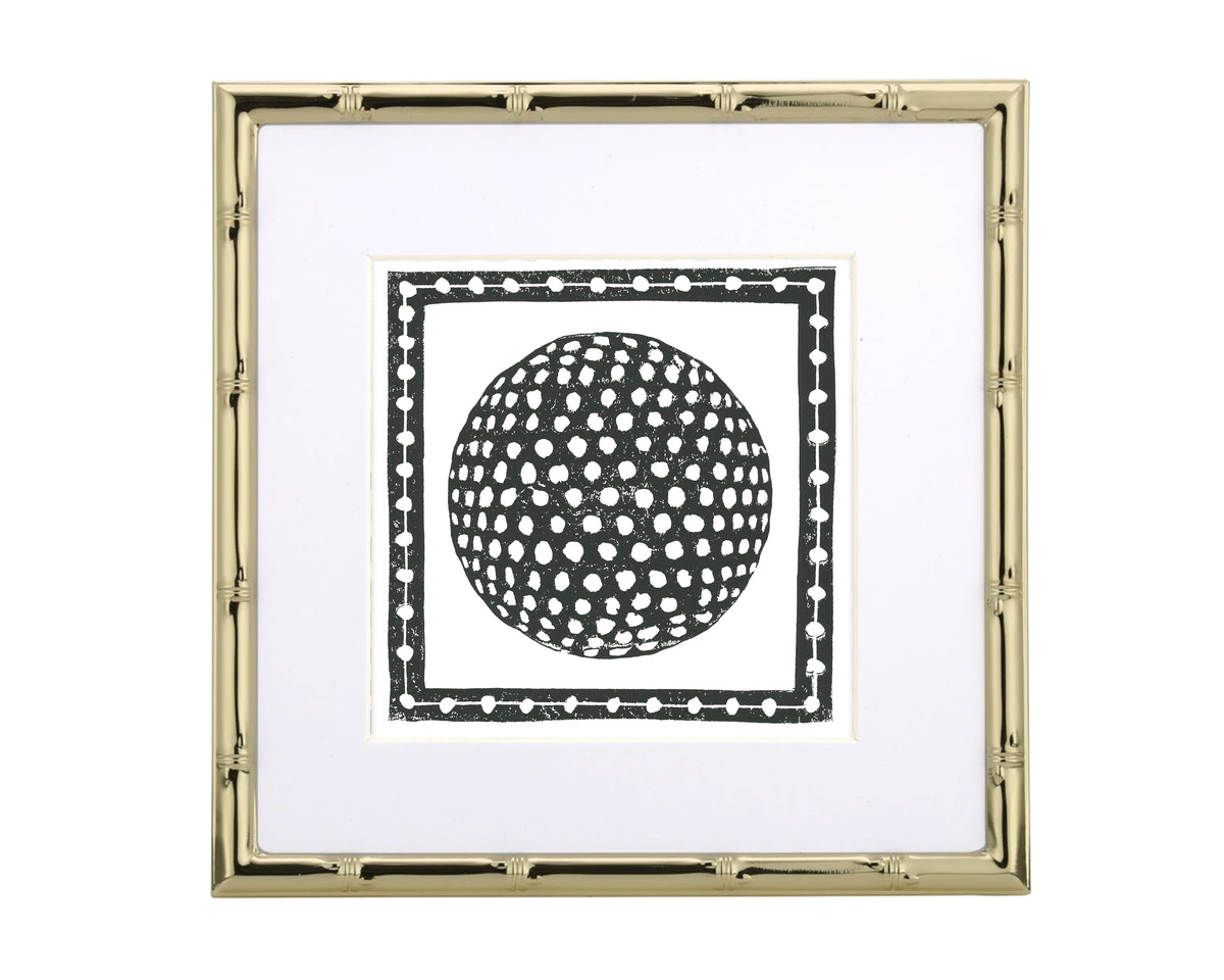 Framed artwork with a black and white golf ball design on a white background
