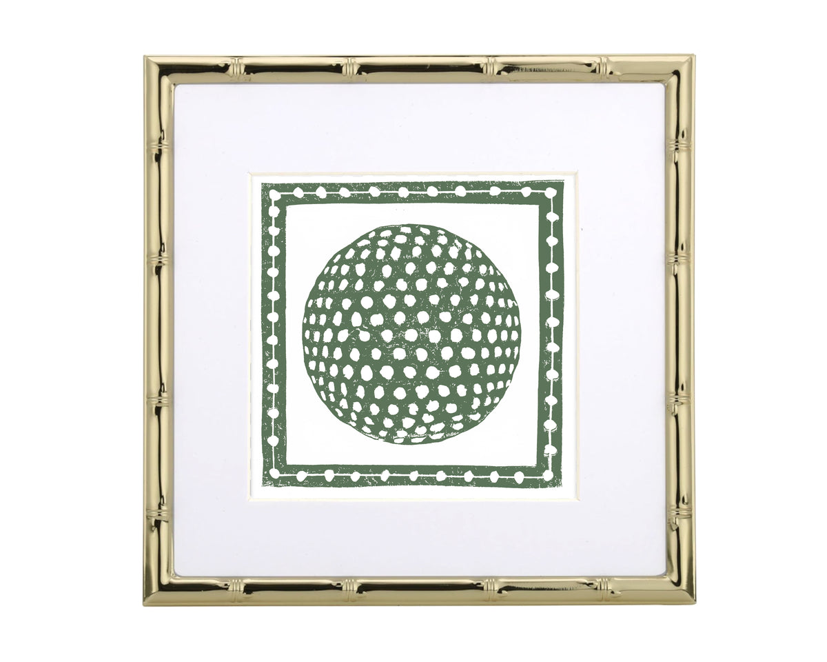 Framed artwork with a green golf ball inside a gold frame on a white background