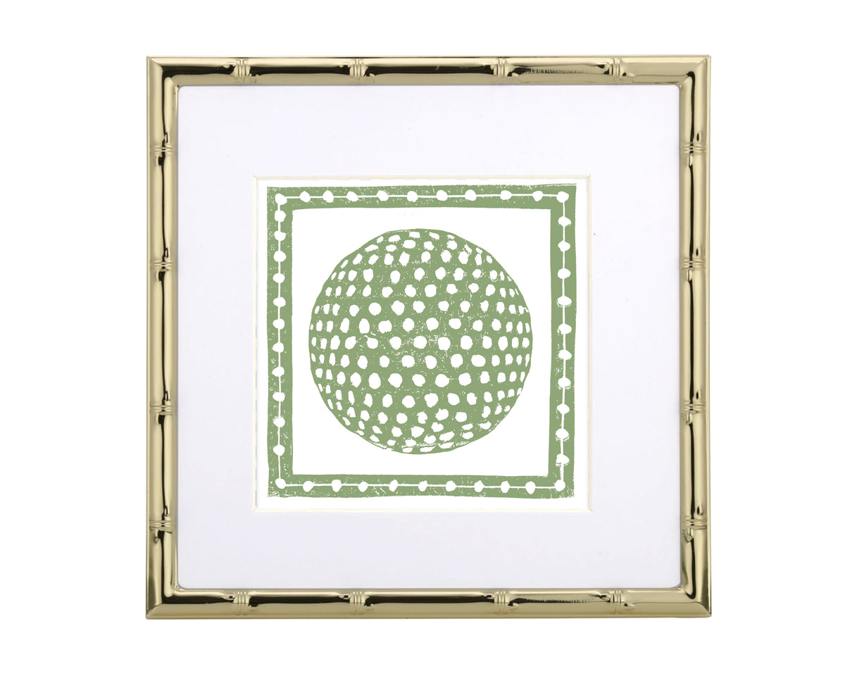 Framed artwork with a green circular golf ball inside a decorative border on a white background