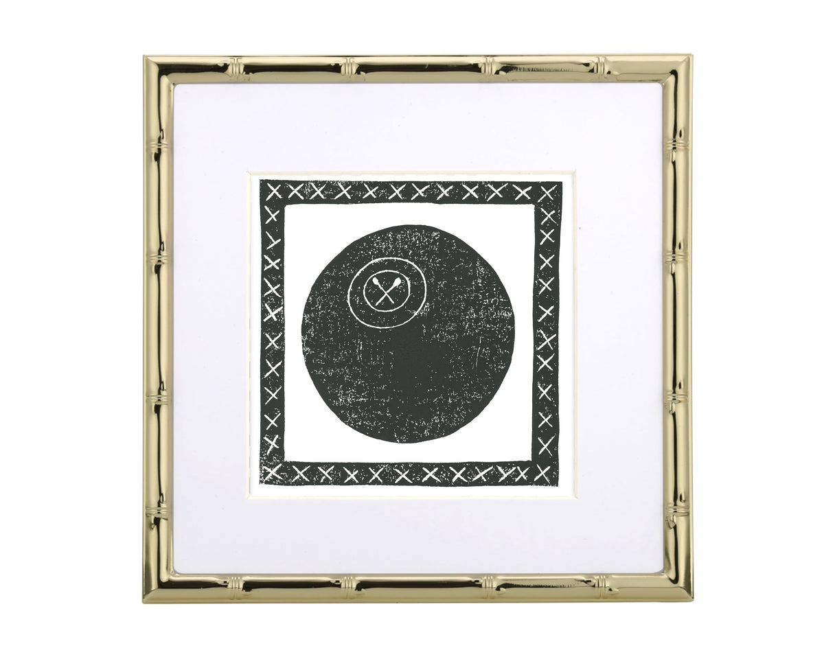 Framed artwork with a black lacrosse ball and cross symbol on a white background