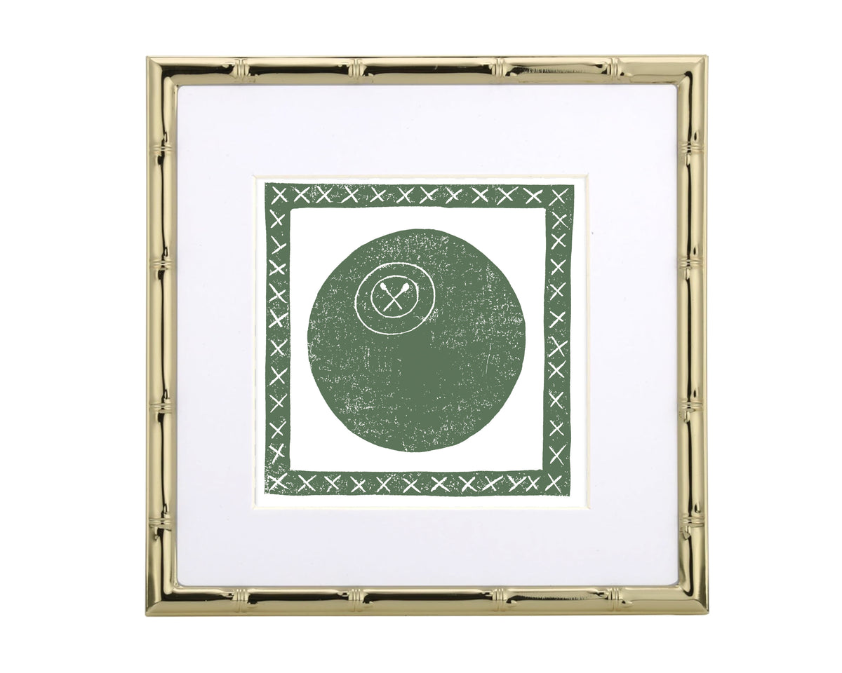 Framed artwork with a green lacrosse ball and white cross symbol on a white background