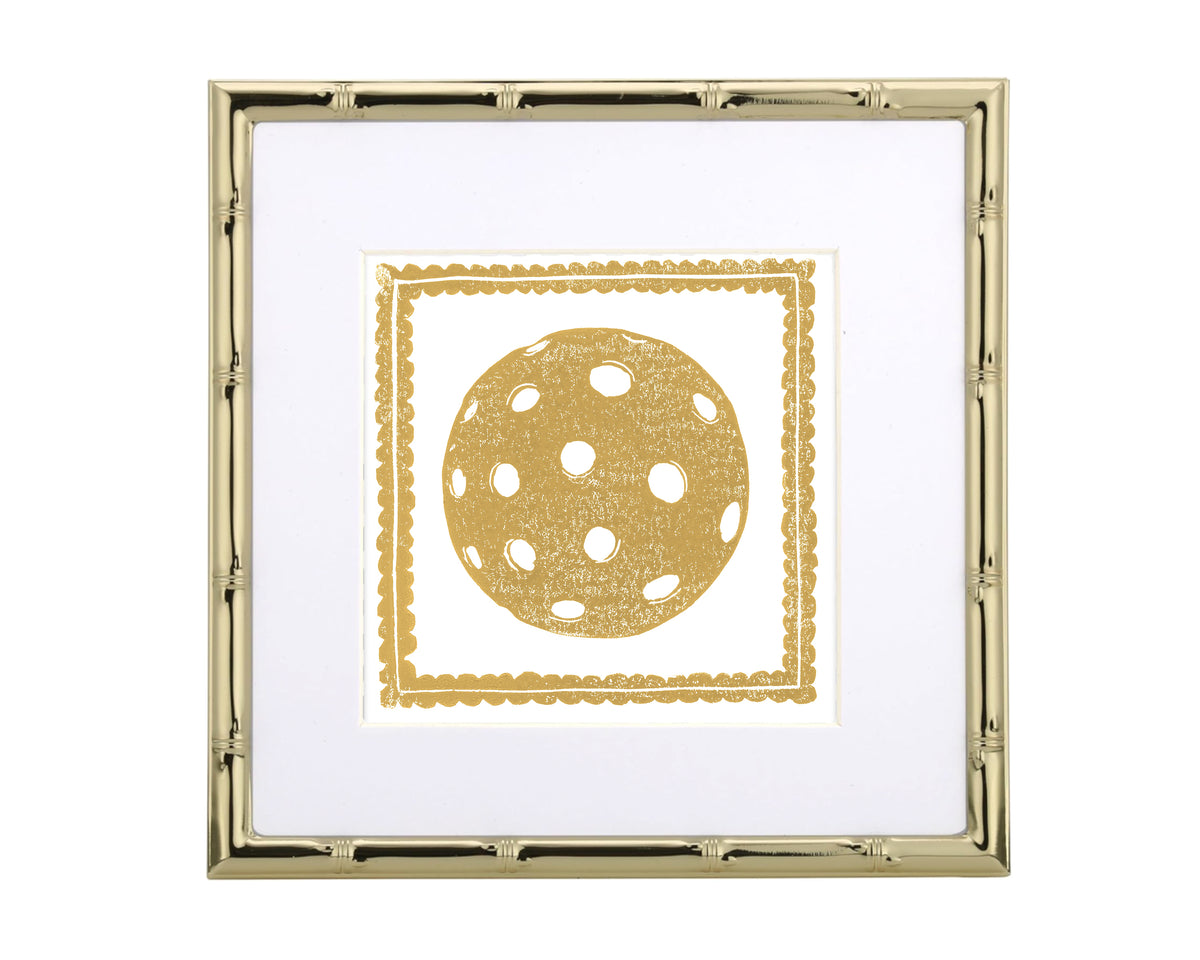 Framed artwork with a gold polka dot pickleball design on a white background