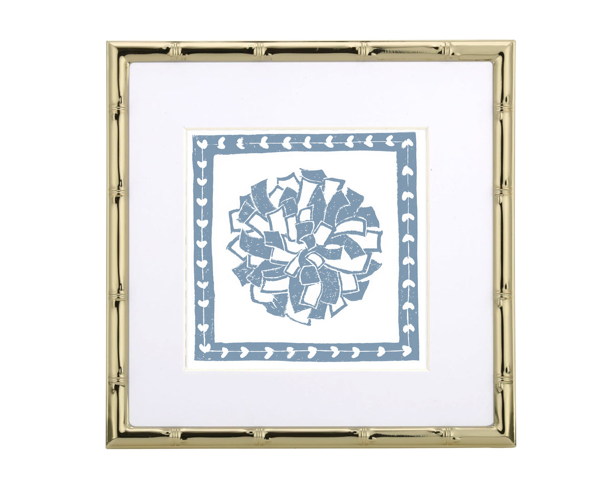 Framed artwork with a blue and white design of a pompon on a white background