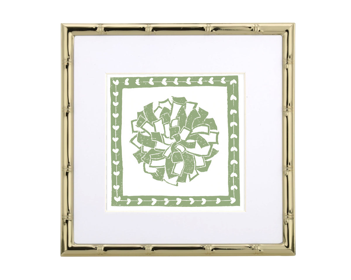 Framed artwork with a green decorative pompon design on a white background