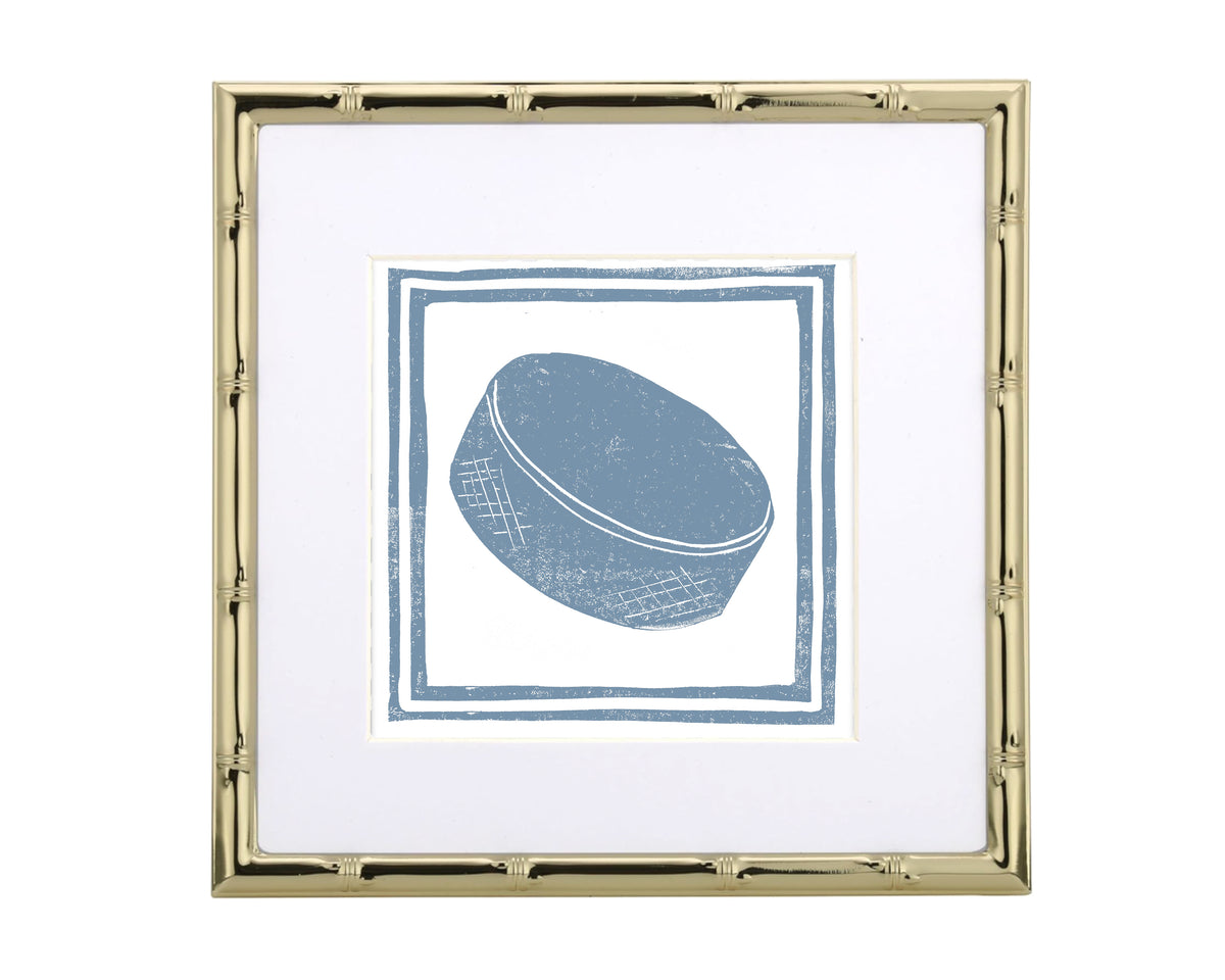 Framed artwork of a blue hockey puck on a white background