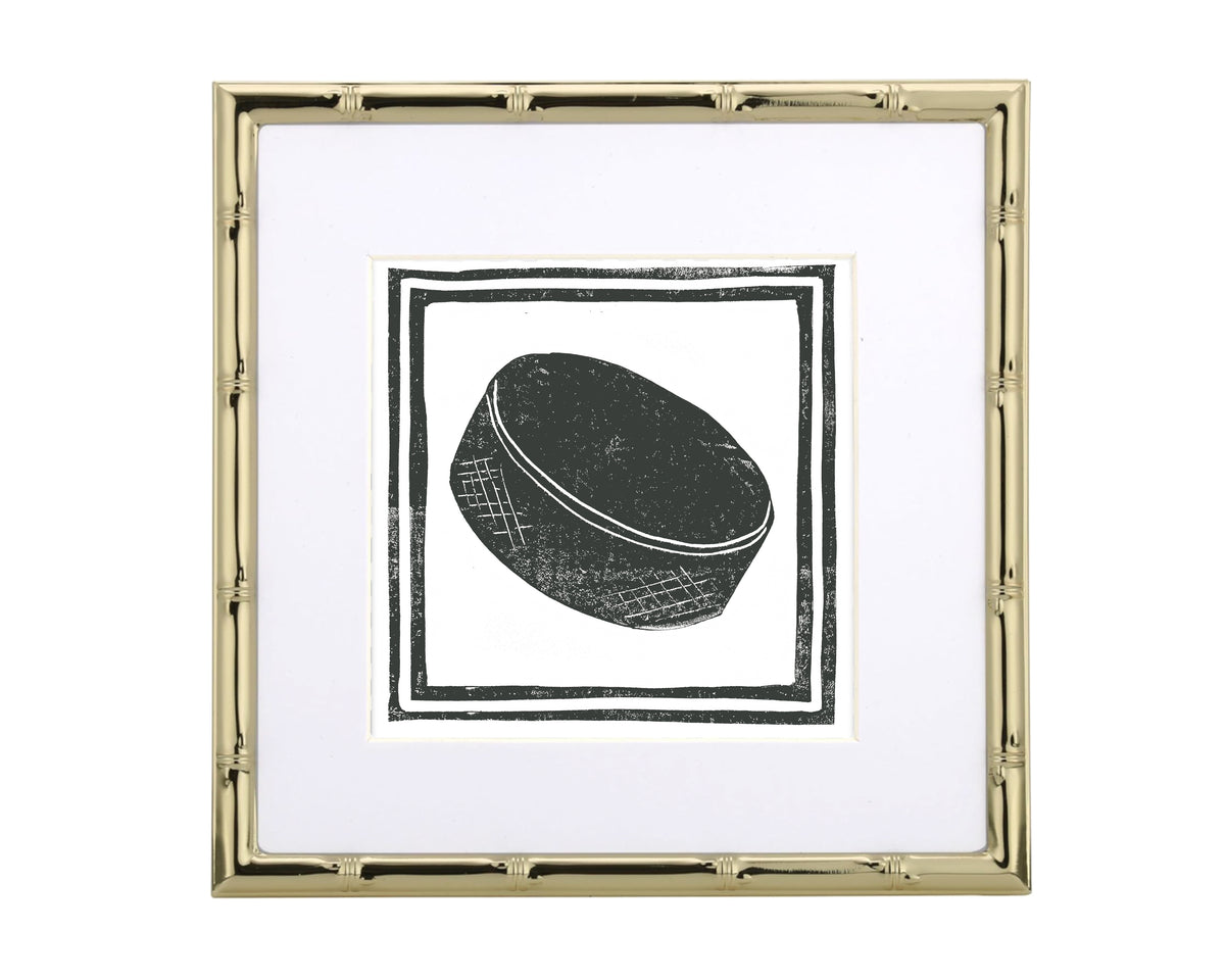 Framed artwork of a hockey puck on a white background