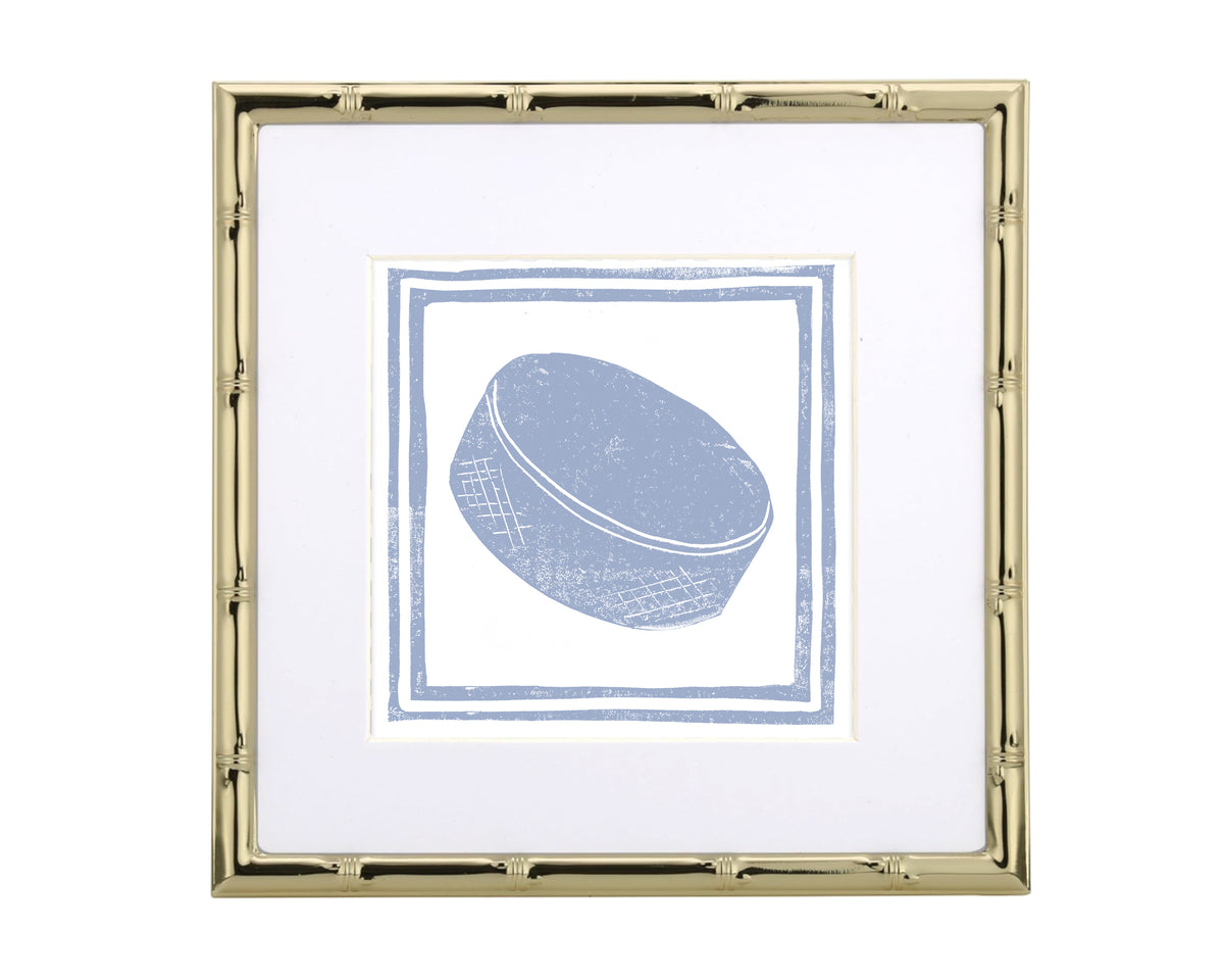 Framed artwork of a blue hockey puck on a white background