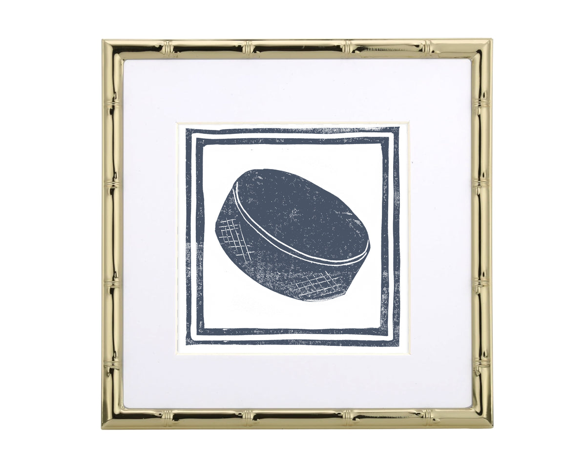 Framed artwork of a hockey puck on a white background