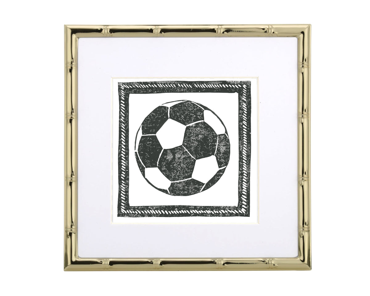 Framed artwork of a soccer ball with a gold frame on a white background
