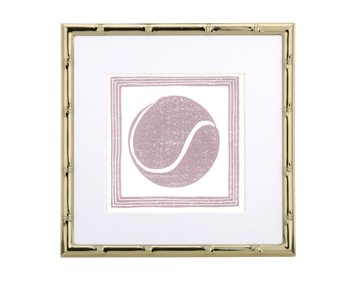 Gold-framed picture with a pink tennis ball design on a white background