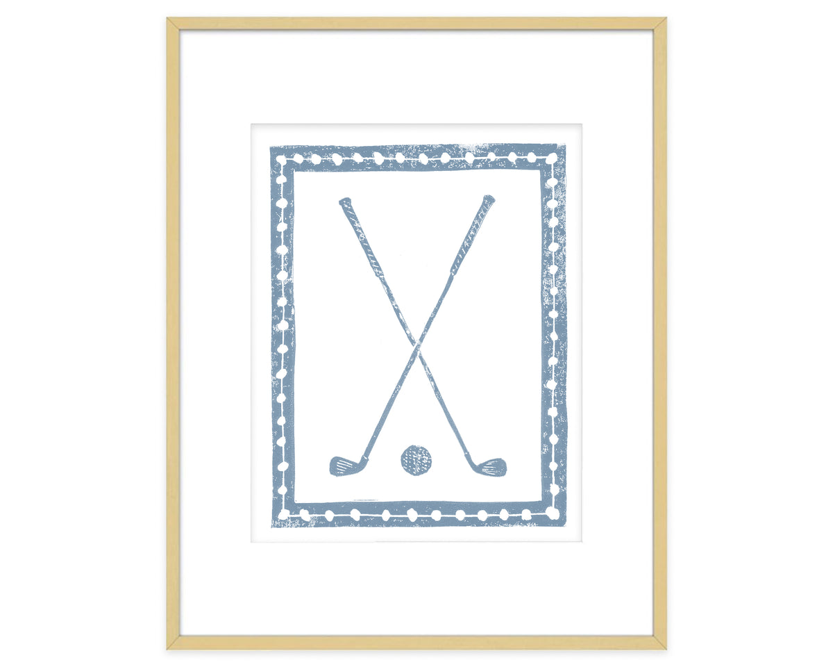 Framed artwork of crossed golf clubs and a ball with a decorative border.