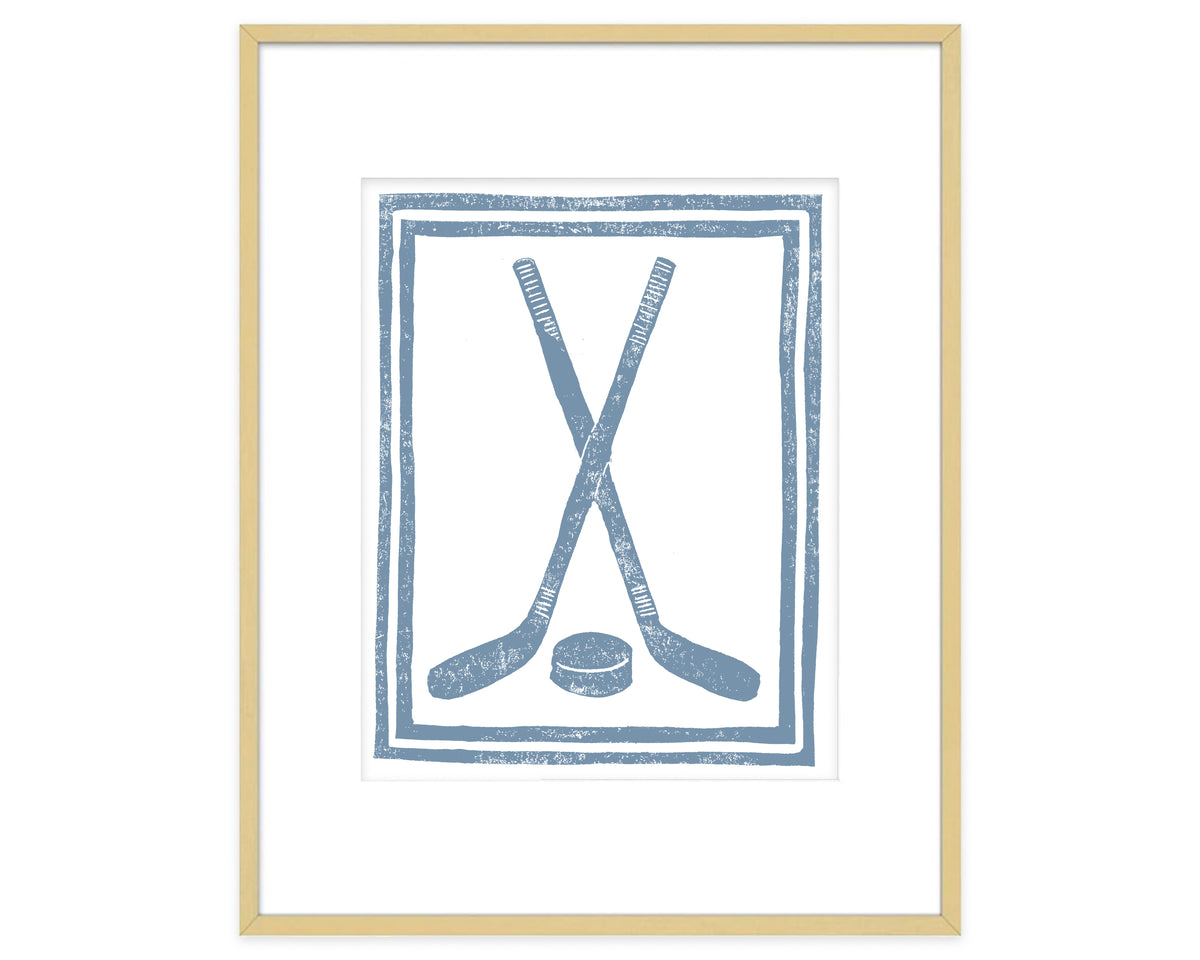 Framed artwork with blue hockey sticks and puck design on a white background