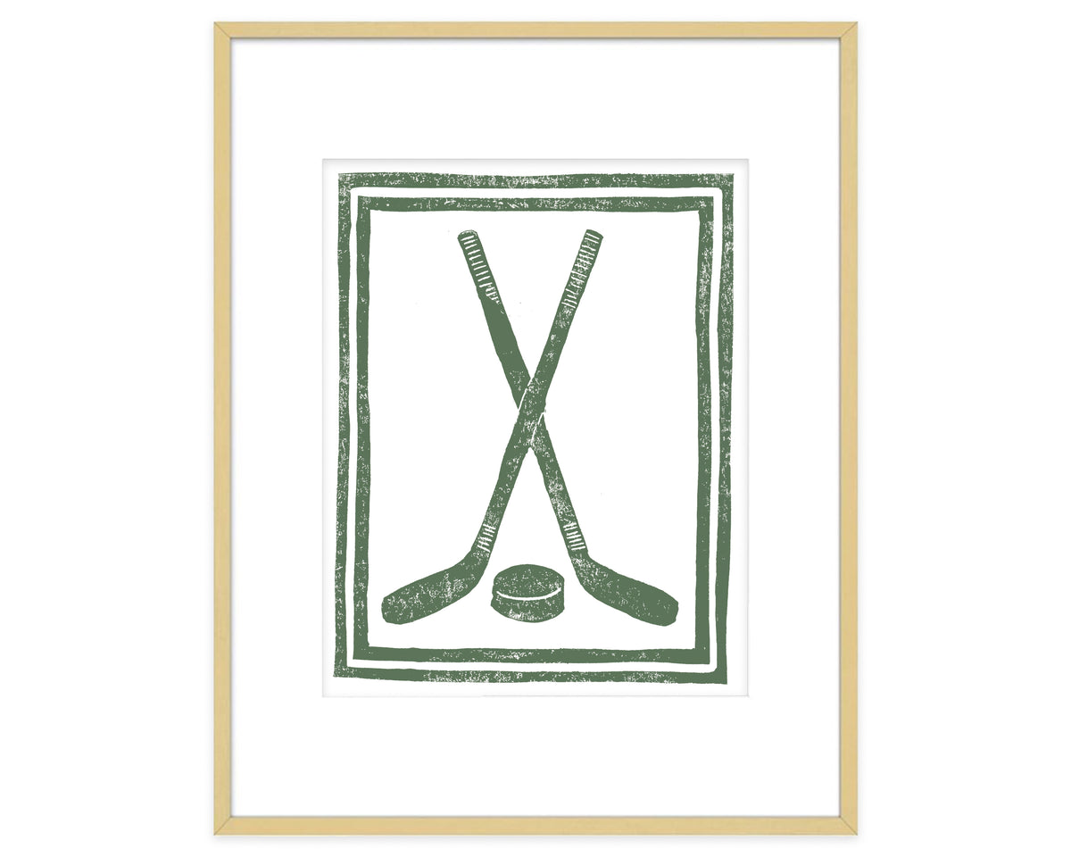 Framed artwork with green hockey sticks and puck design on a white background