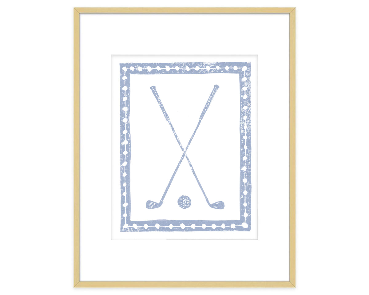 Framed artwork of crossed golf clubs and a golf ball with a decorative border.