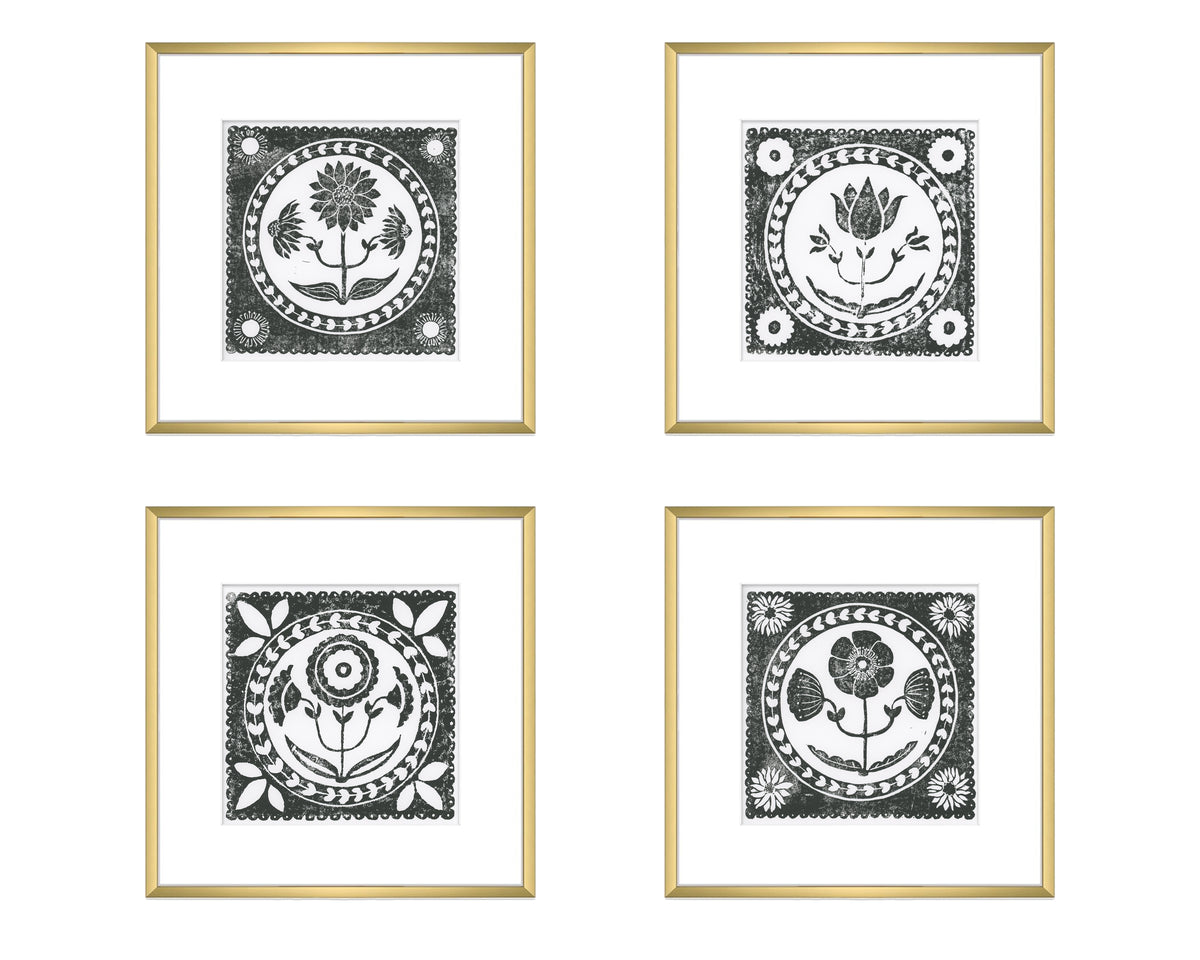 Four framed black and white floral designs on a white background