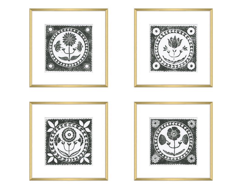 Four framed black and white floral designs on a white background