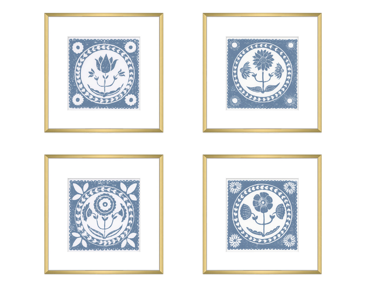 Four framed prints with blue floral designs on a white background