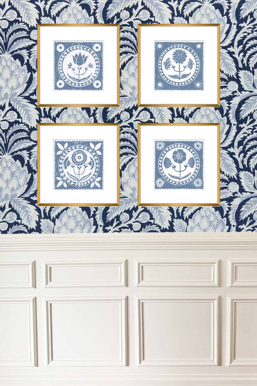 Four framed blue and white decorative prints on a patterned wall.