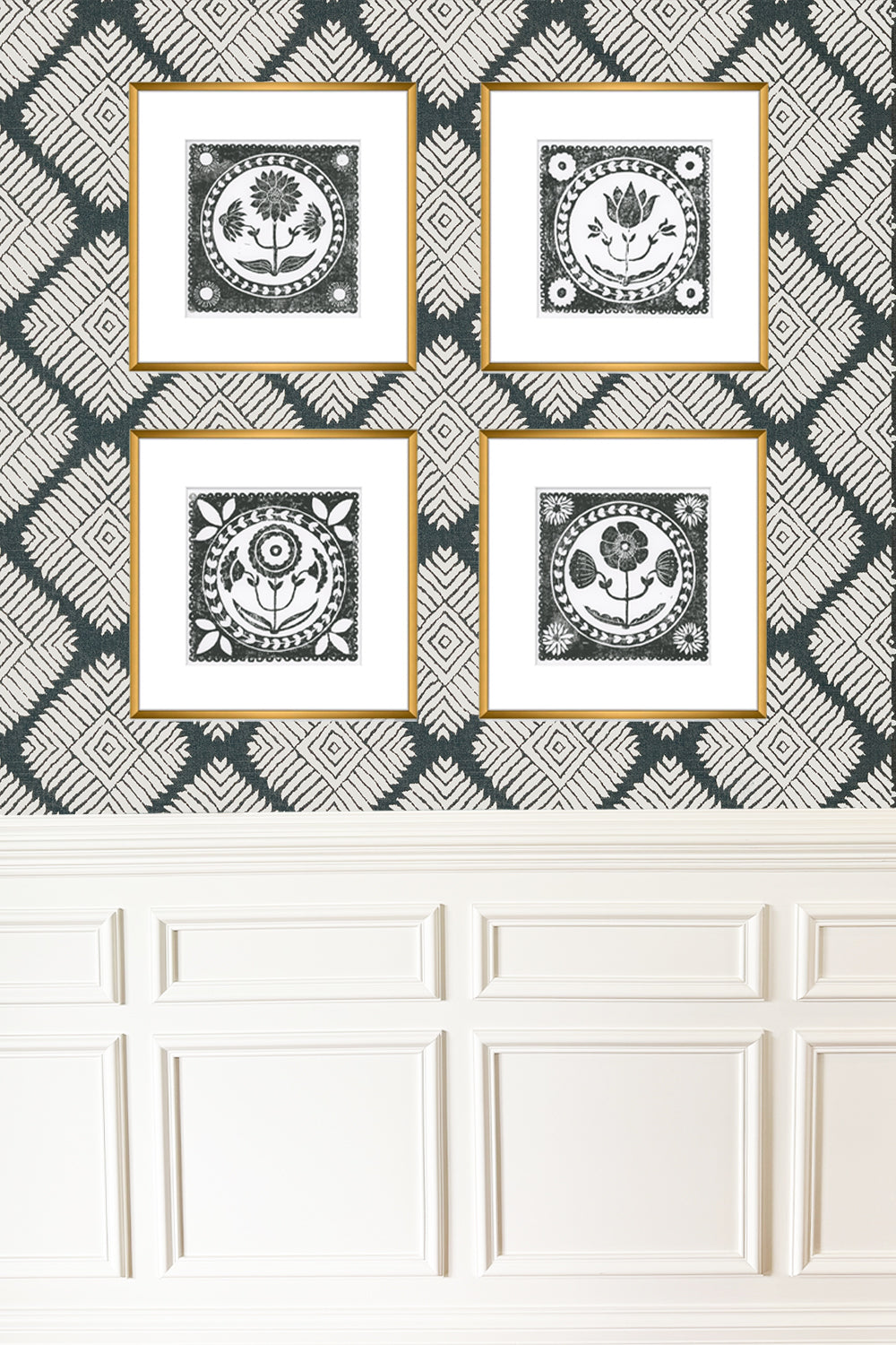 Four framed artworks with geometric patterns on a wall with a geometric patterned wallpaper.