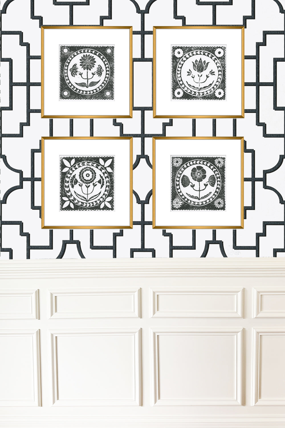Four framed black and white prints on a decorative wall with geometric patterns.