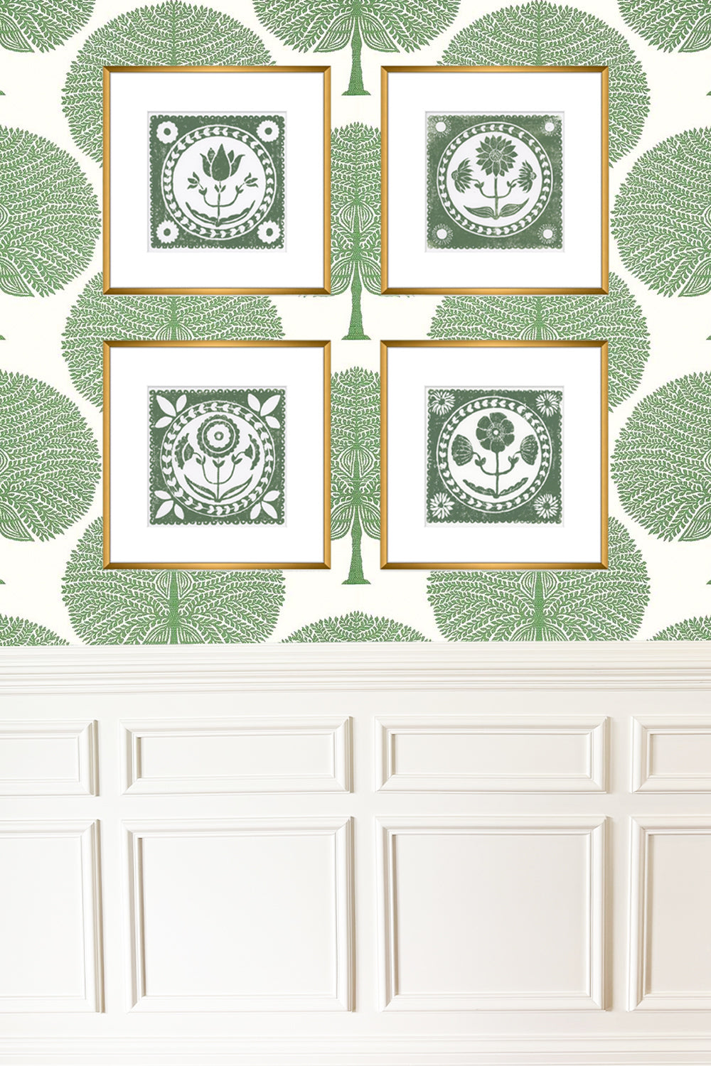 Four framed decorative prints with a green leaf pattern on a white wall.