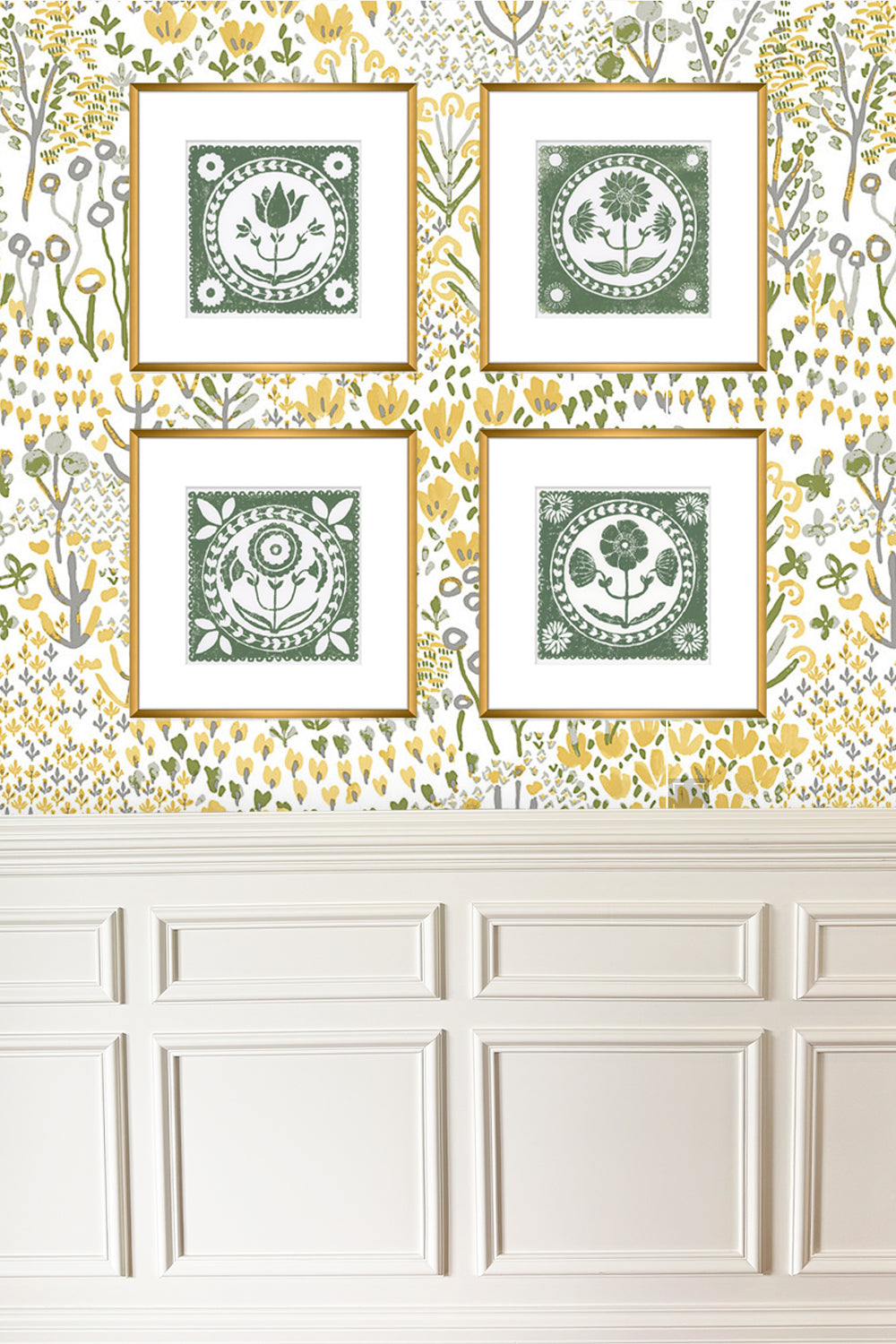 Four framed decorative prints on a wall with floral wallpaper
