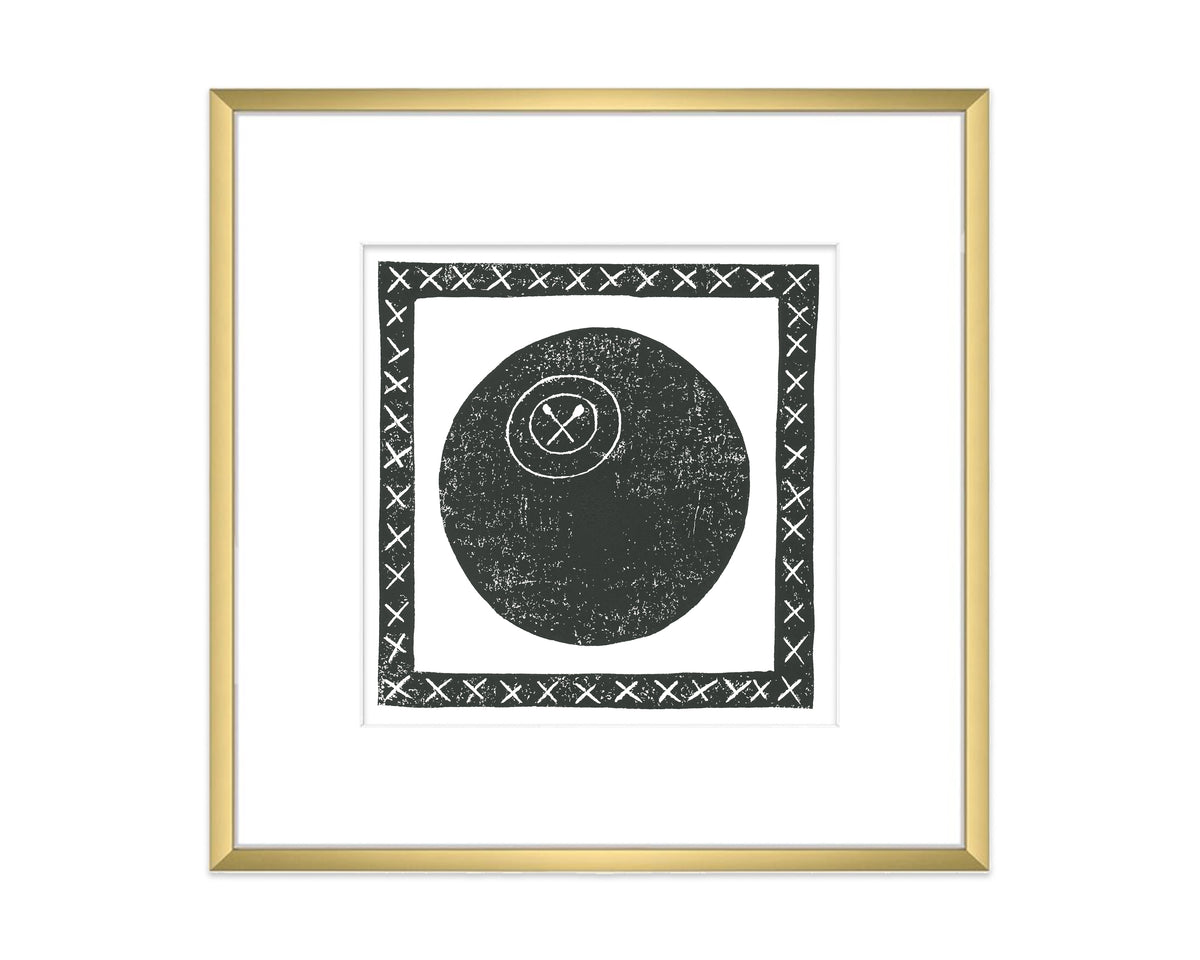 Framed artwork with a black lacrosse ball and cross symbol on a white background