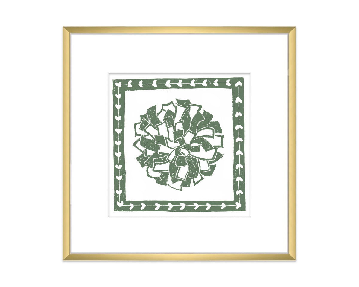 Framed artwork with a green decorative pompon design on a white background