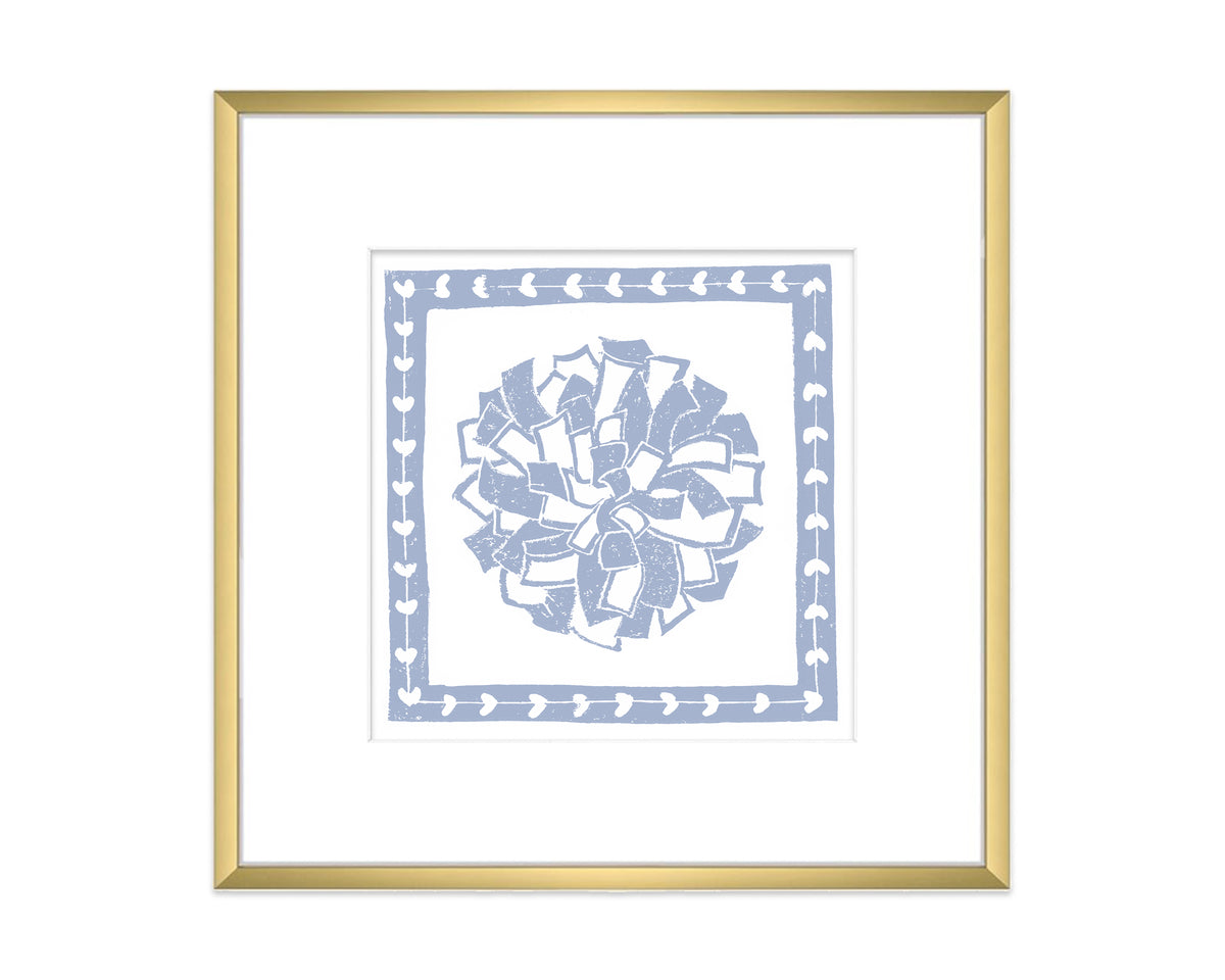 Framed artwork of a blue and white decorative pompon with a gold frame on a white background