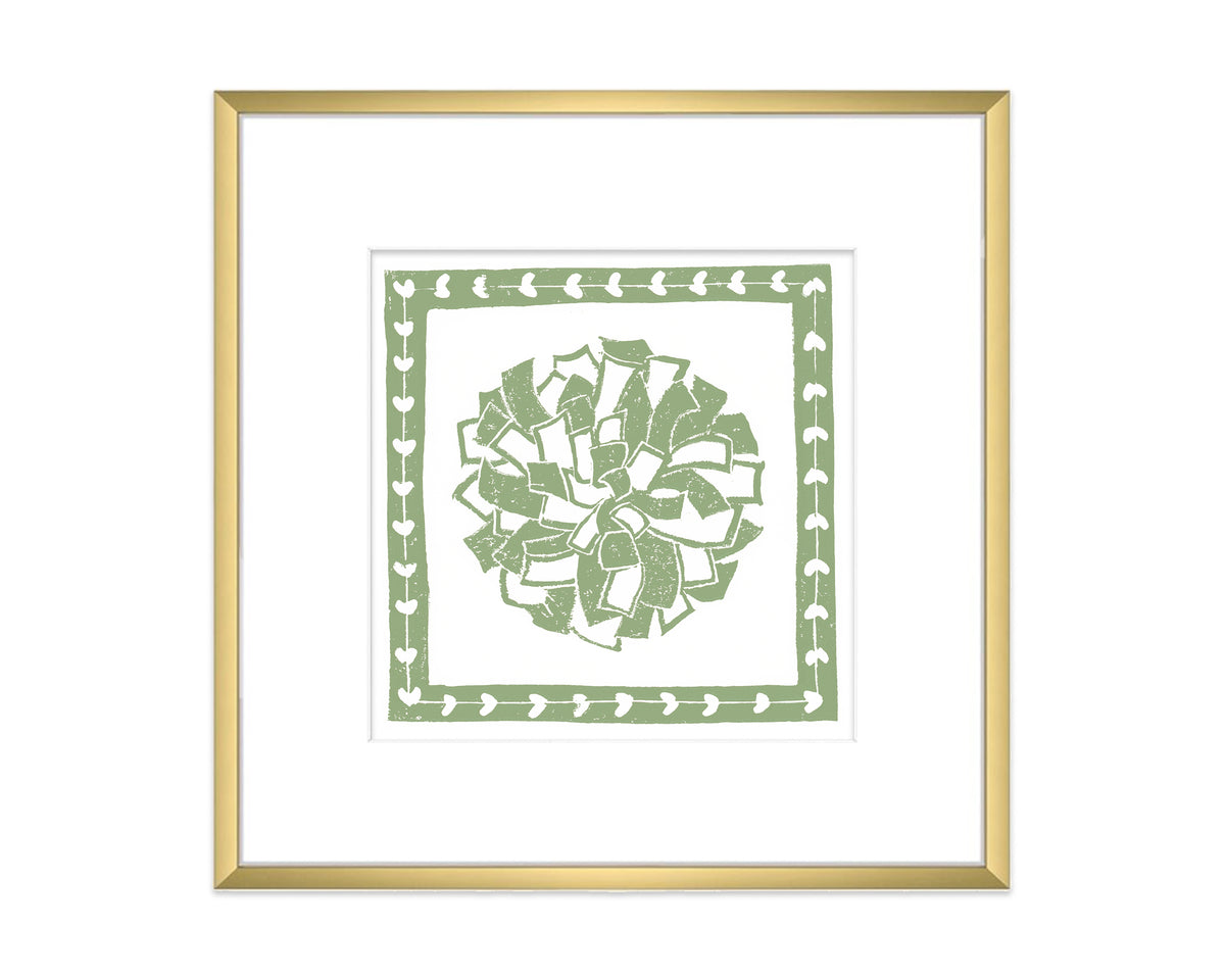 Framed artwork with a green decorative pompon design on a white background