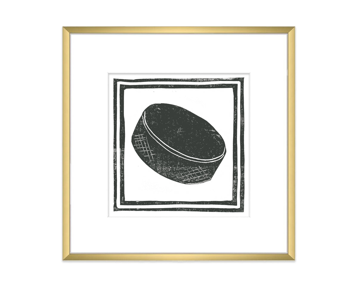 Framed black and white illustration of a hockey puck on a white background