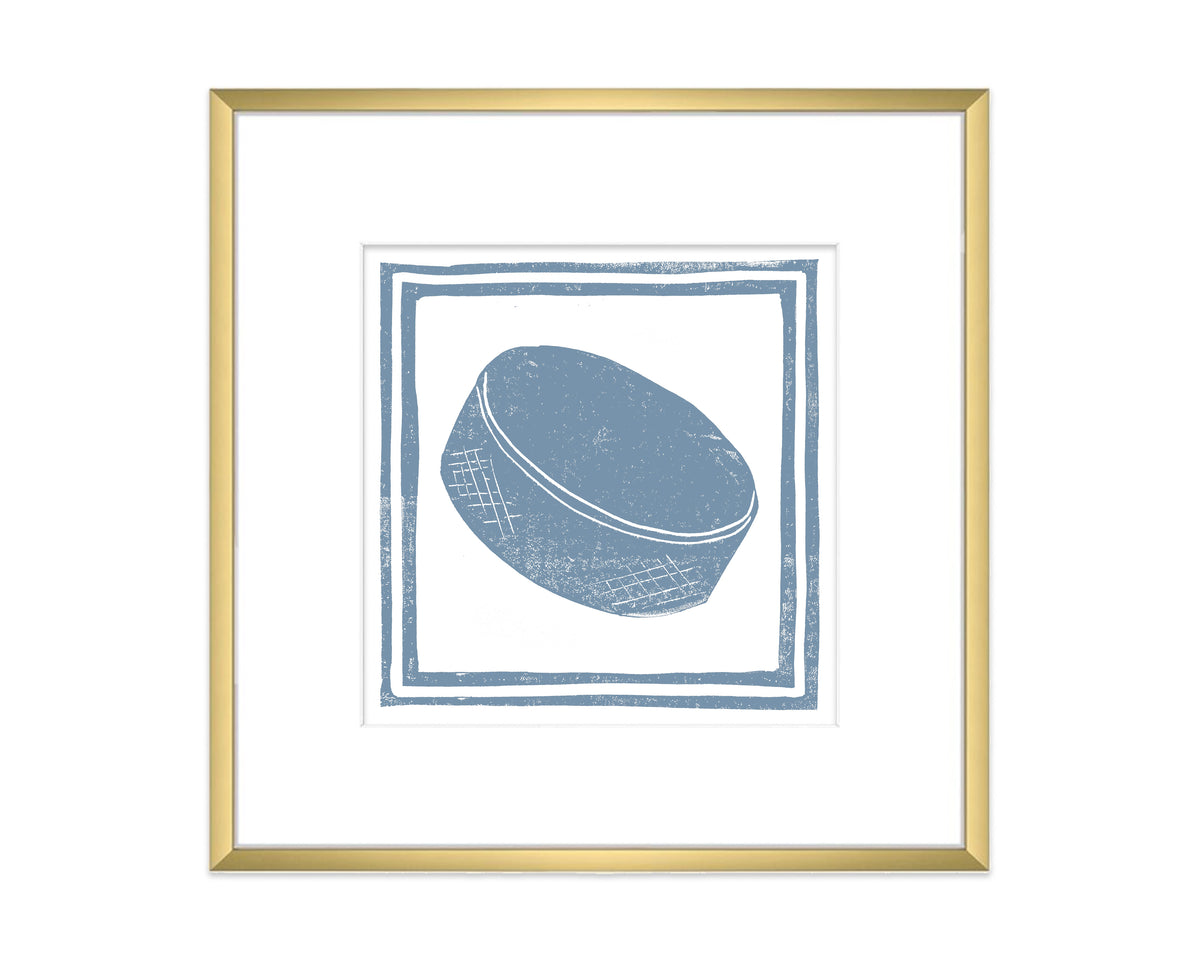 Framed artwork of a blue hockey puck on a white background