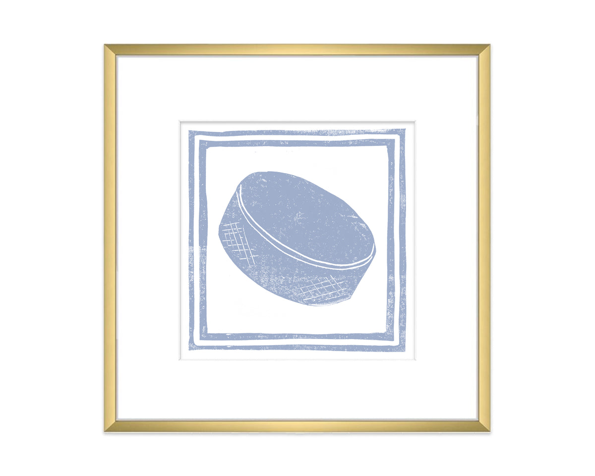 Framed artwork of a blue hockey puck on a white background