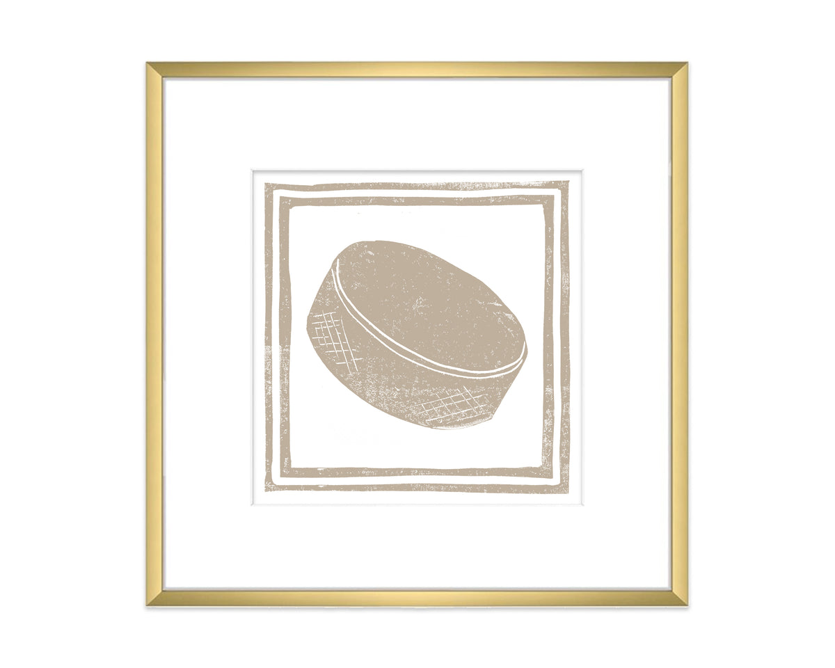 Framed artwork of a textured hockey puck on a white background