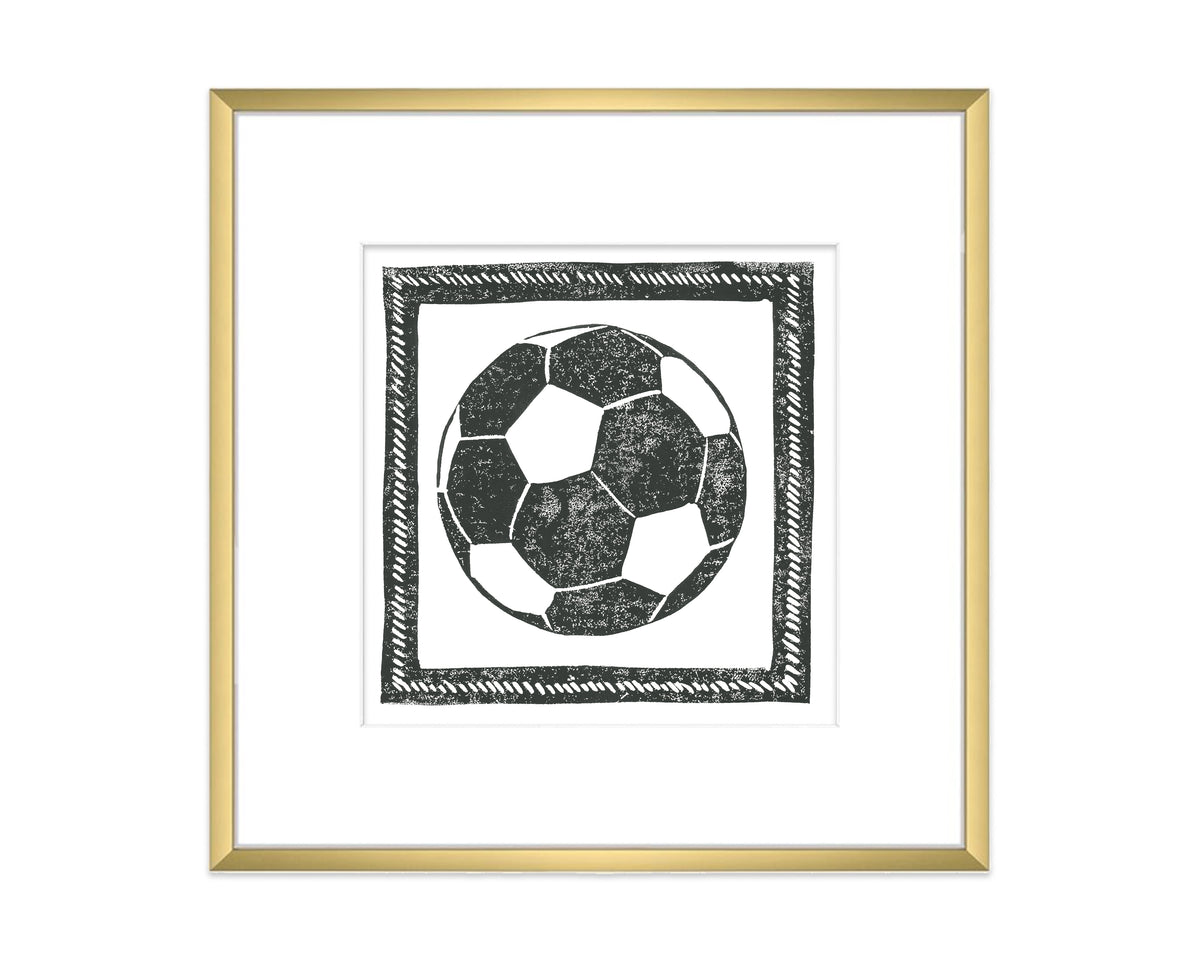 Framed artwork of a soccer ball with a gold frame on a white background