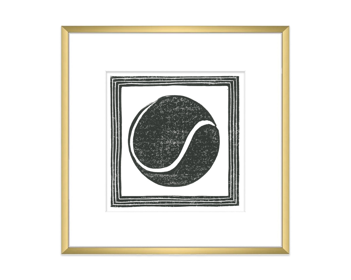 Framed artwork with a black tennis ball design on a white background
