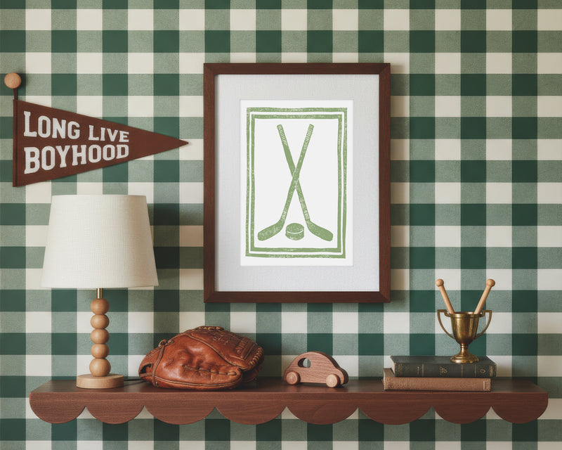 Framed artwork on a wall with checkered pattern, lamp, and decorative items.
