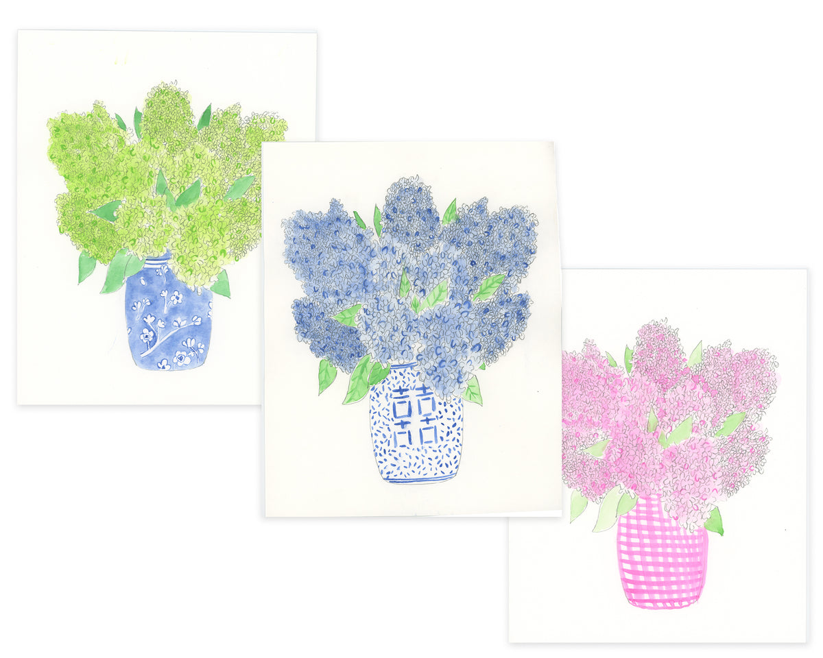 Three floral arrangements in blue, green, and pink vases on a white background