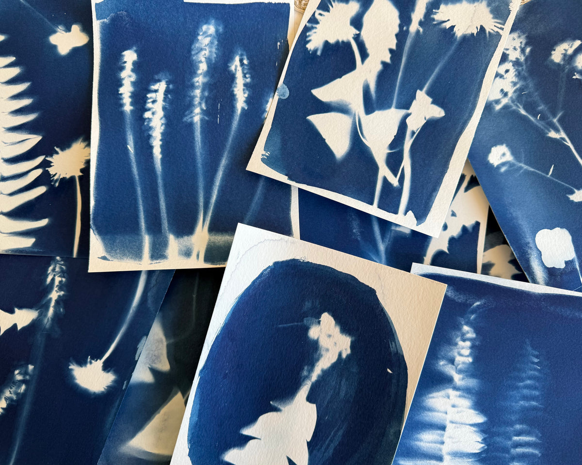 Blue and white developed floral designs on white paper
