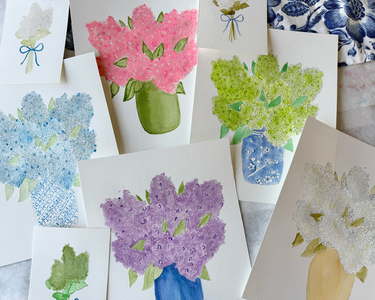 Collection of paintings with floral designs on a textured surface.