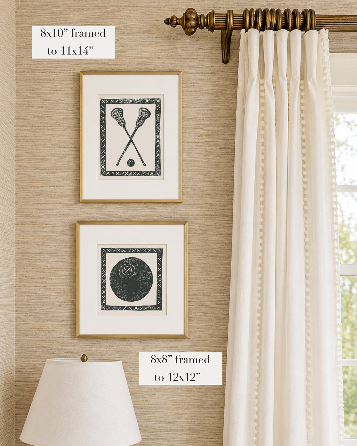 Framed black and white lacrosse themed artwork on a tan grasscloth wallpapered wall with a white window treatment and lampshade