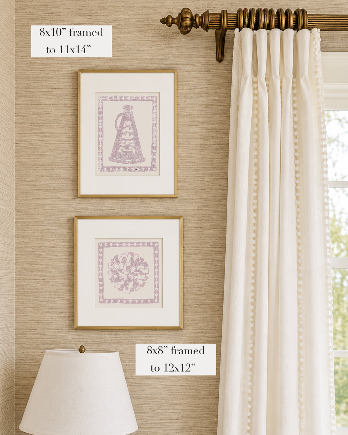 Framed mauve and white cheerleading themed artwork on a tan grasscloth wallpapered wall with a white window treatment and lampshade