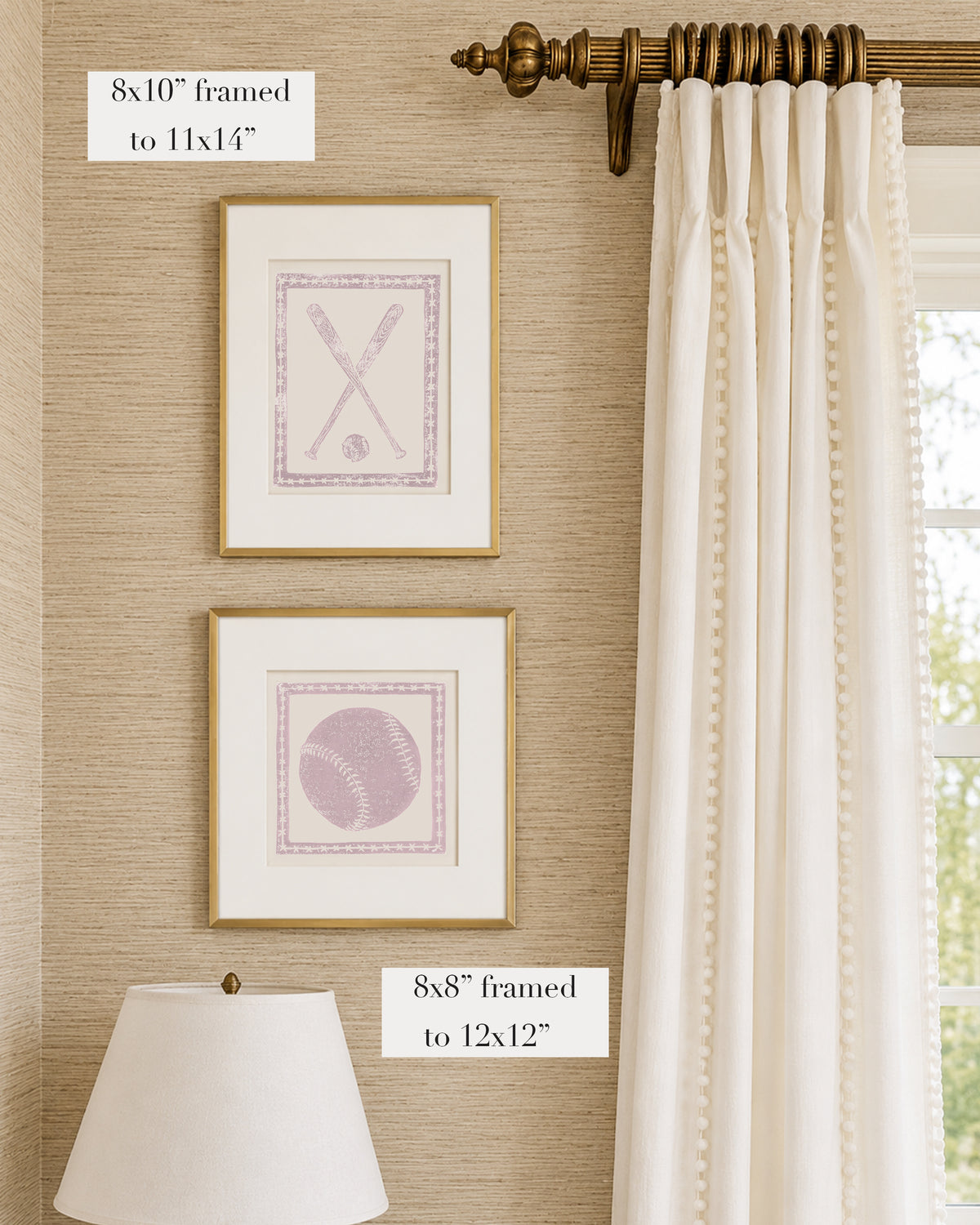 Framed mauve and white softball themed artwork on a tan grasscloth wallpapered wall with a white window treatment and lampshade