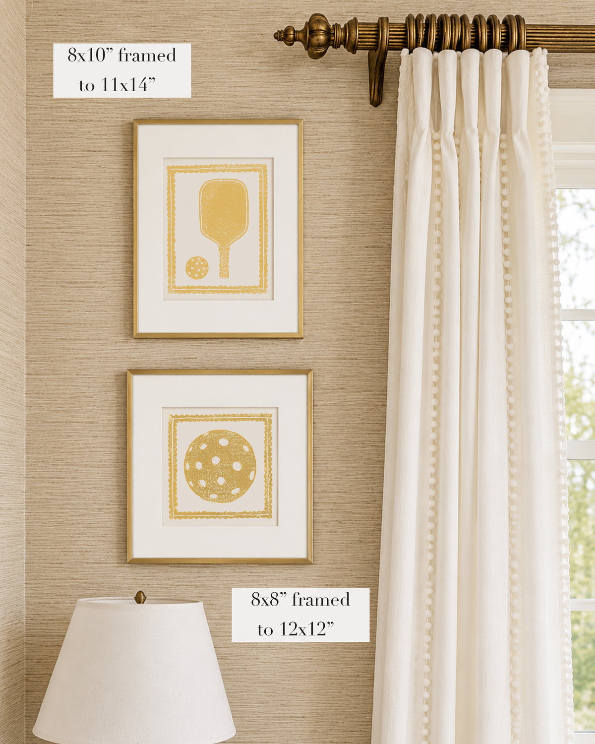 Framed mustard yellow and white pickleball themed artwork on a tan grasscloth wallpapered wall with a white window treatment and lampshade