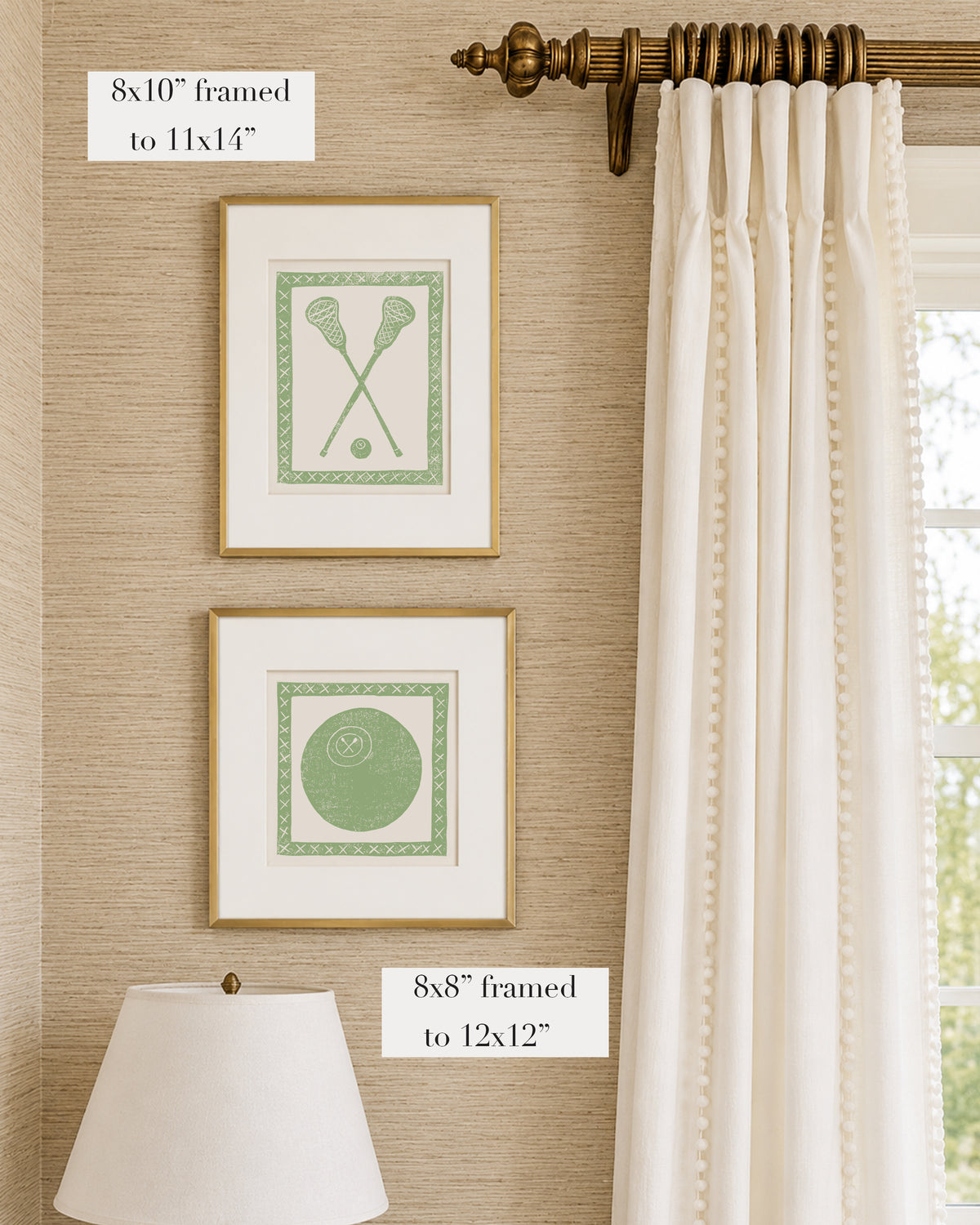 Framed sage green and white lacrosse themed artwork on a tan grasscloth wallpapered wall with a white window treatment and lampshade