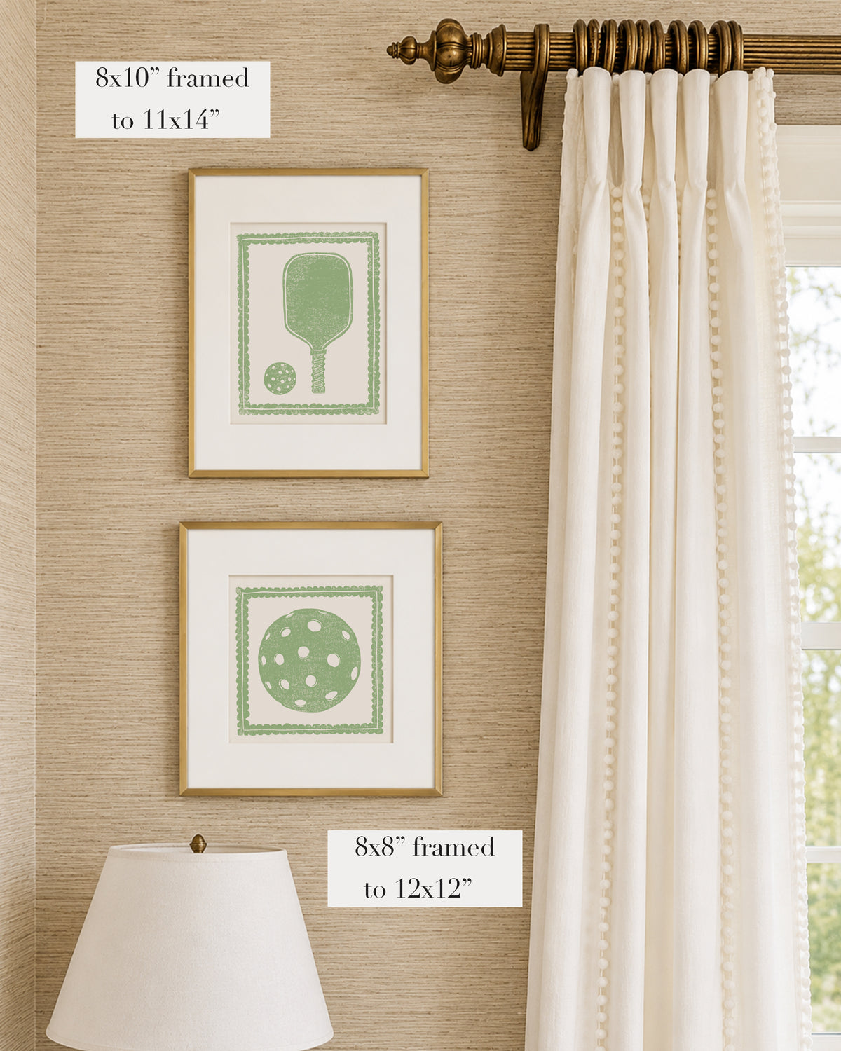 Framed sage green and white pickleball themed artwork on a tan grasscloth wallpapered wall with a white window treatment and lampshade