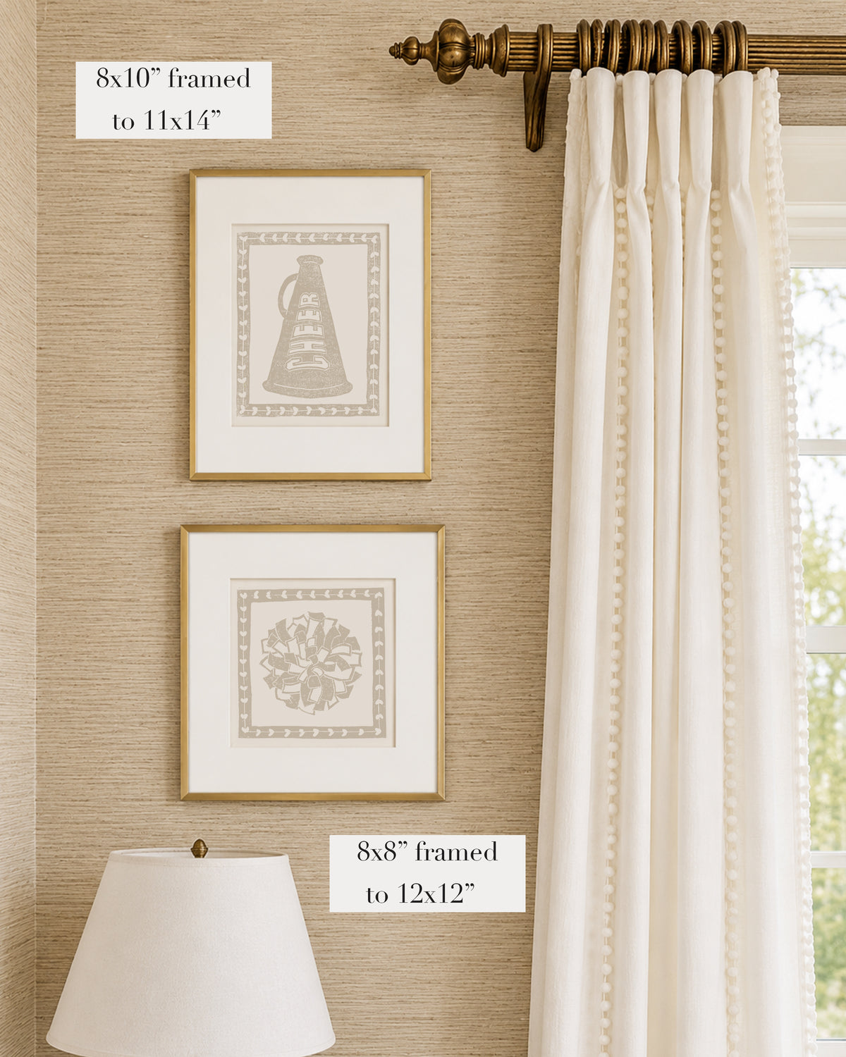 Framed light brown and white cheerleading themed artwork on a tan grasscloth wallpapered wall with a white window treatment and lampshade